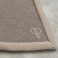 Load image into Gallery viewer, close up of a boucle fabric and sherpa fleece neutral colour blanket with PP monogram