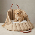 Load image into Gallery viewer, maltipoo puppy sitting inside a beige pet carrier with a plain background