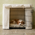 Load image into Gallery viewer, avapoo puppy rests inside a cream boucle fabric dog crate set on lime wash background.