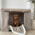 Load image into Gallery viewer, Dog sitting inside a wire crate with a beige cover and white lining in a room.
