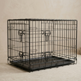 Load image into Gallery viewer, black wire dog crate with POSH POOS metal brand plate on a soft studio background

