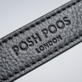 Load image into Gallery viewer, Close-up of a textured black leather dog lead with 'POSH POOS LONDON' branding.
