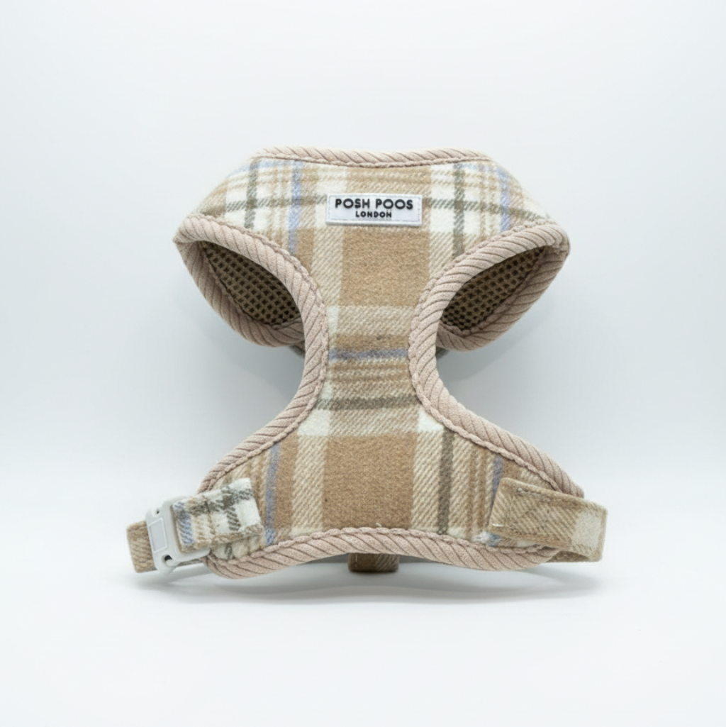Plaid patterned puppy harness with visible  posh poos brand label on a white background